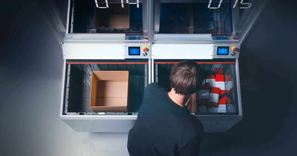 Man picking socks from right side of AutoStore VersaPort into empty carton on the left side