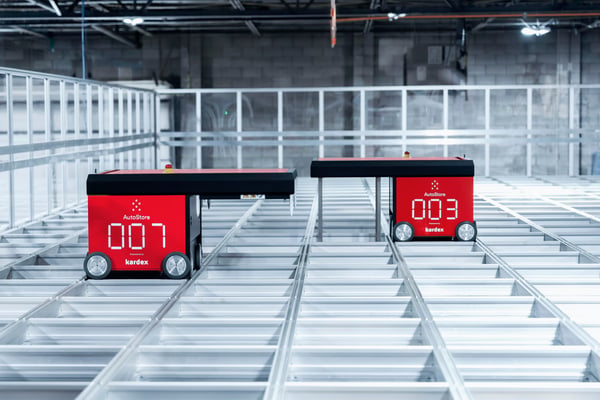 Red AutoStore robots on top of grid | Kardex