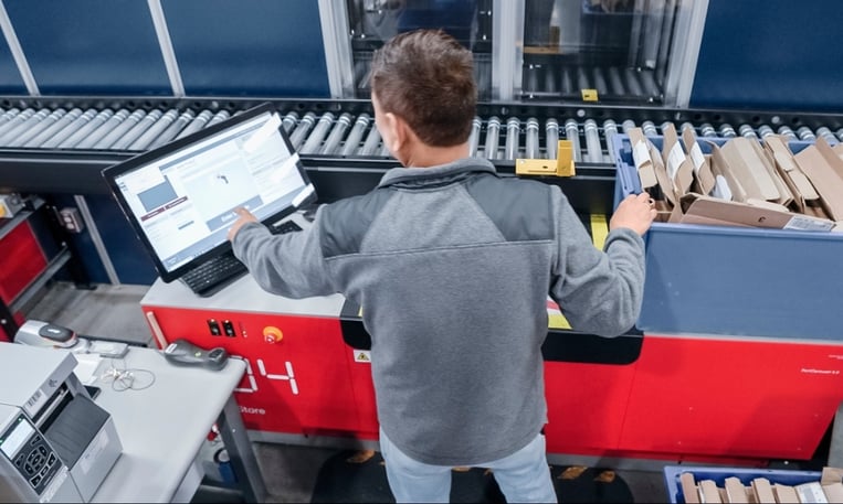 Warehouse operator at AutoStore Port interacting with Kardex FulfillX software