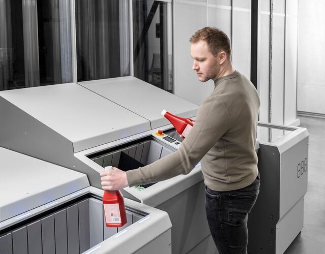 FusionPort Staging - man picking and placing ketchup bottles