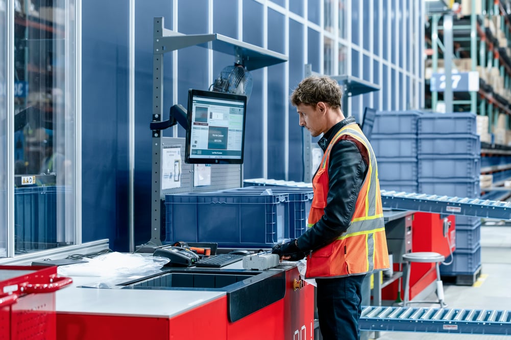 Warehouse operator at AutoStore Port engaging with Kardex FulfillX screen