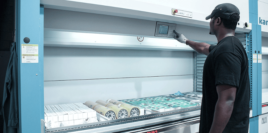 A worker using a vlm in a small warehouse