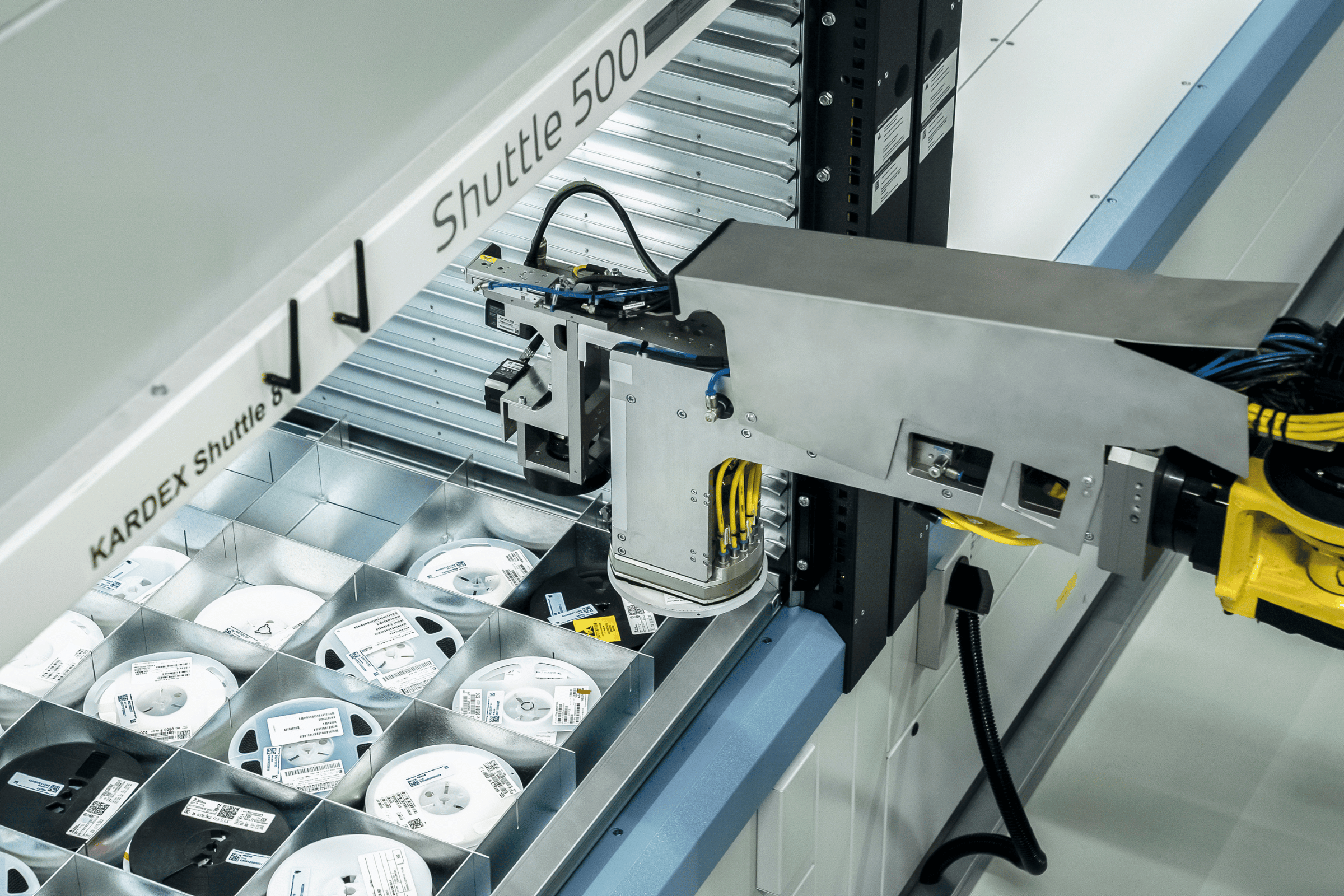 a robotic arm picks from a vertical lift module