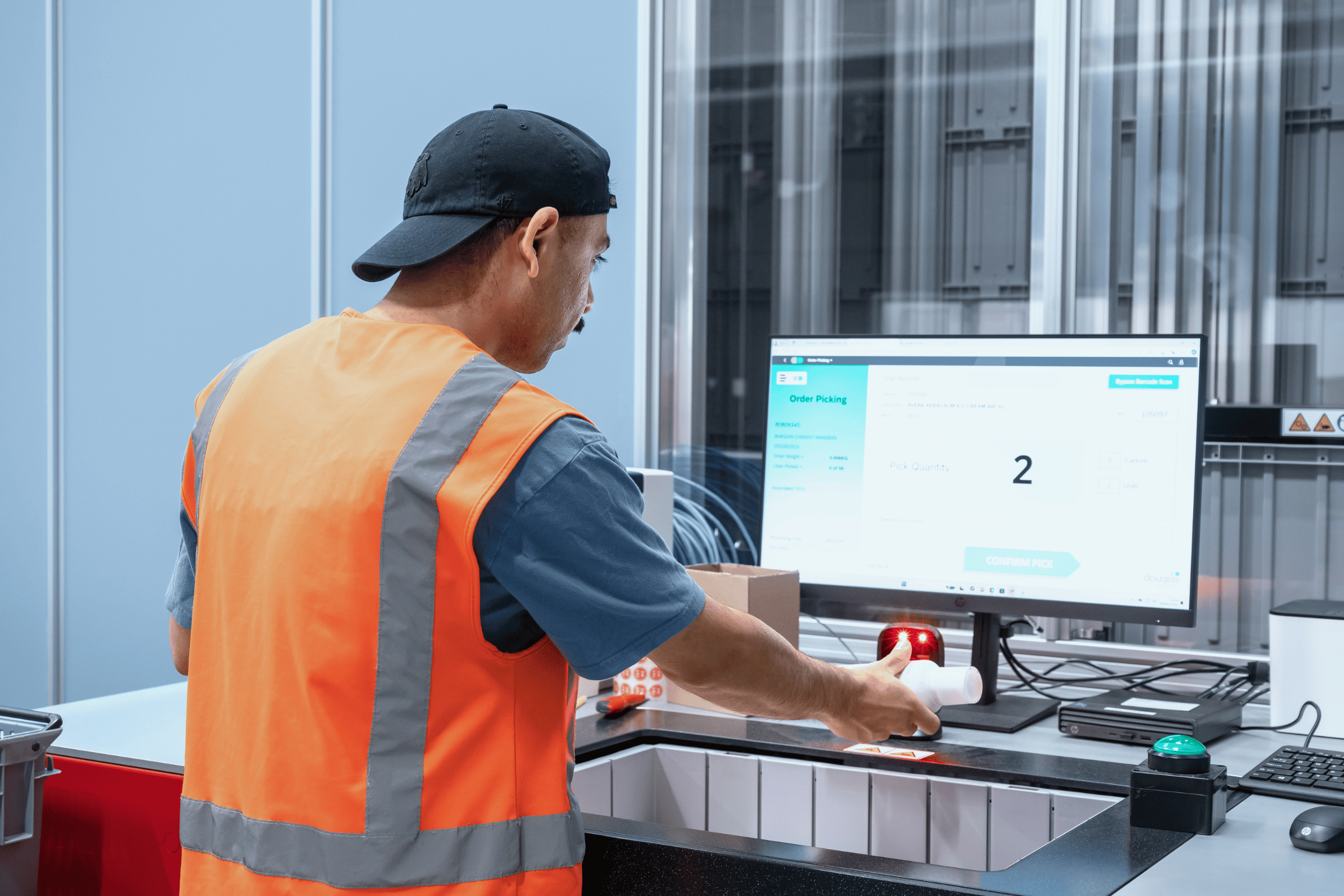 a worker uses inventory management software with simple barcoding