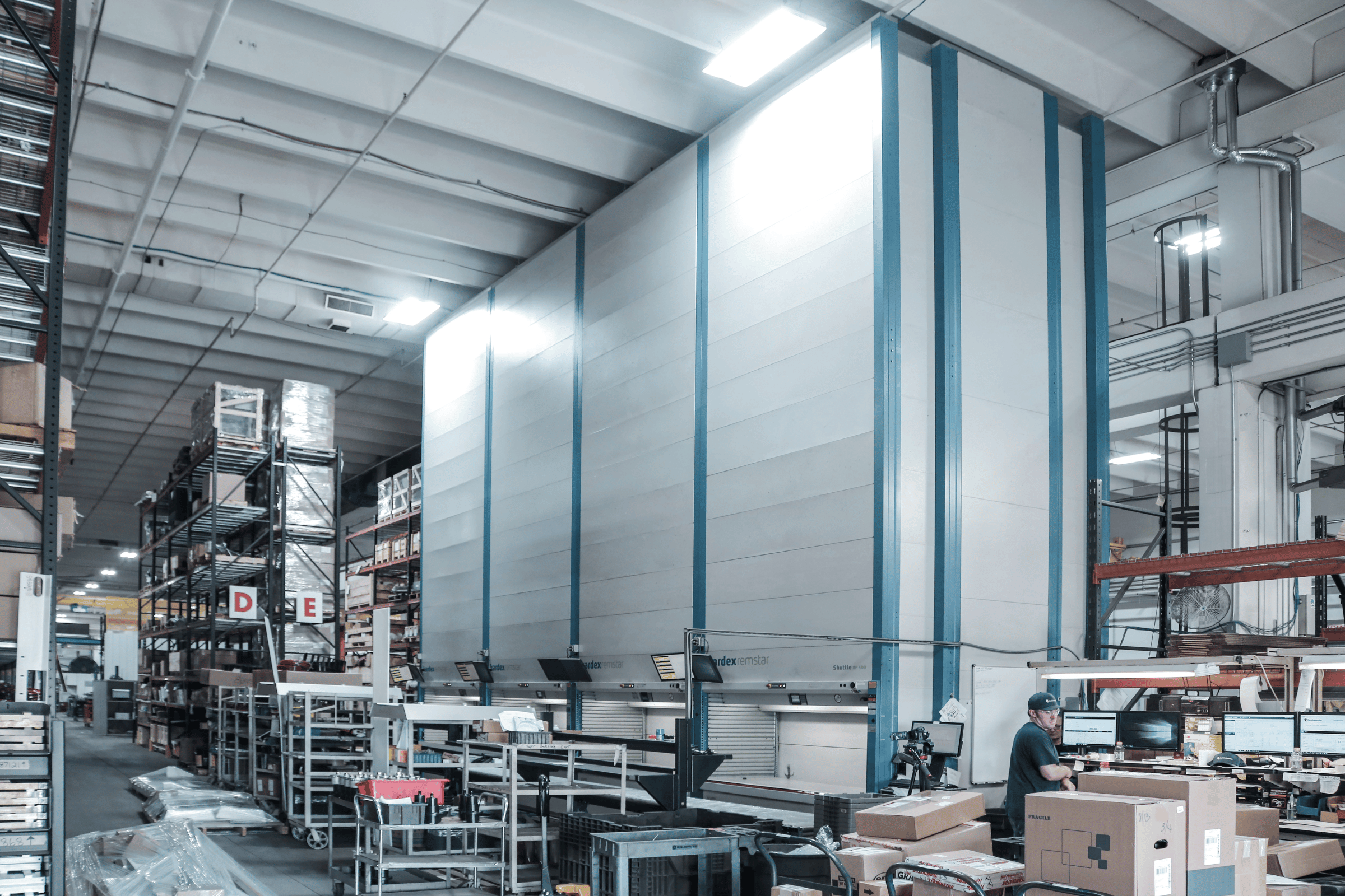 four vertical lift modules in a small warehouse