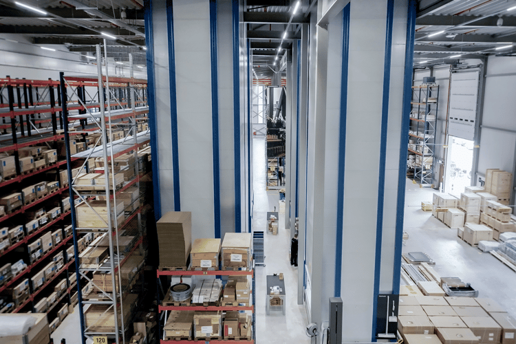 traditional warehouse shelves alongside VLMs