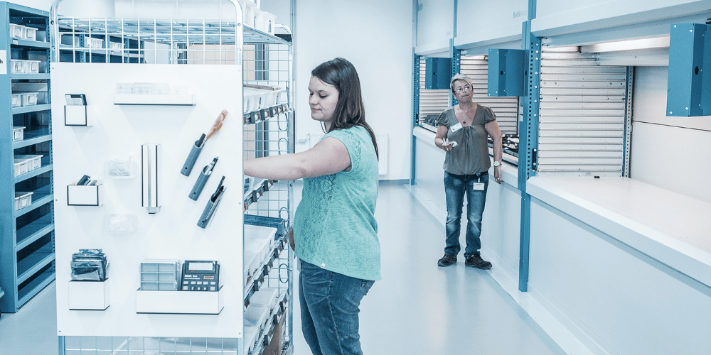 three vertical lift modules with traditional shelving for picking