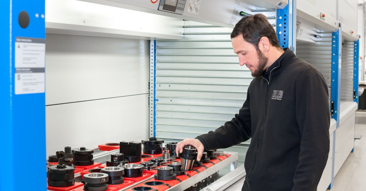 A worker choosing a tool from an automated tool crib