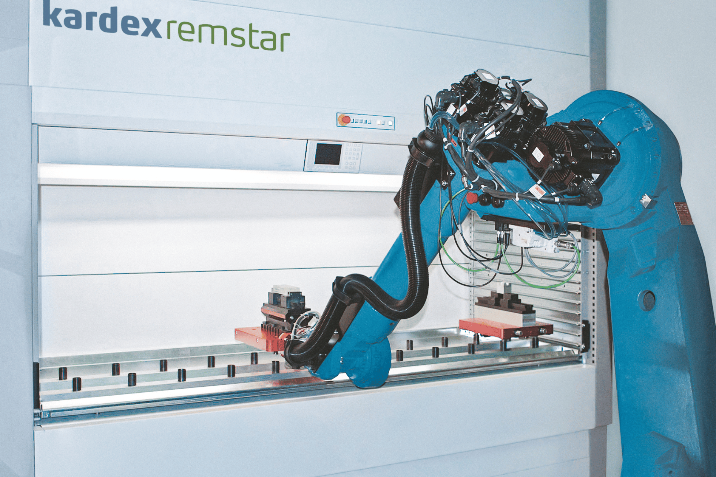 A blue robotic arm picks from a VLM